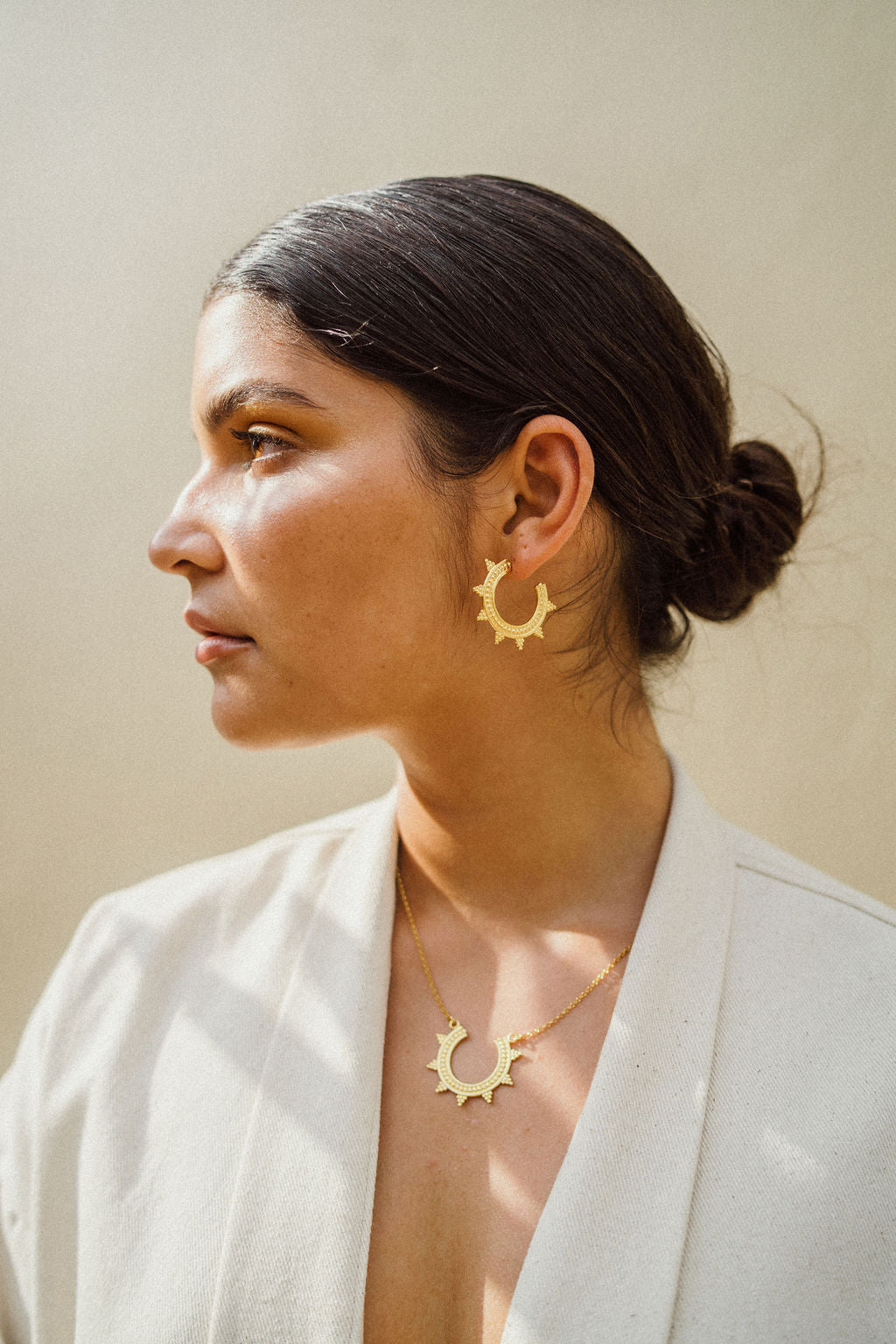 Woman model, wearing handmade golden jewellery, necklace, earrings